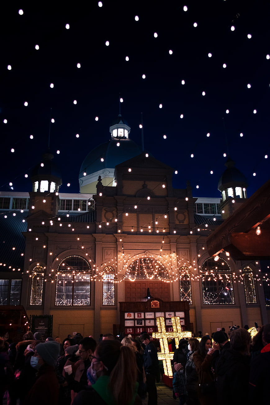 Christmas Market Night Scene with Festive Lights and Crowd