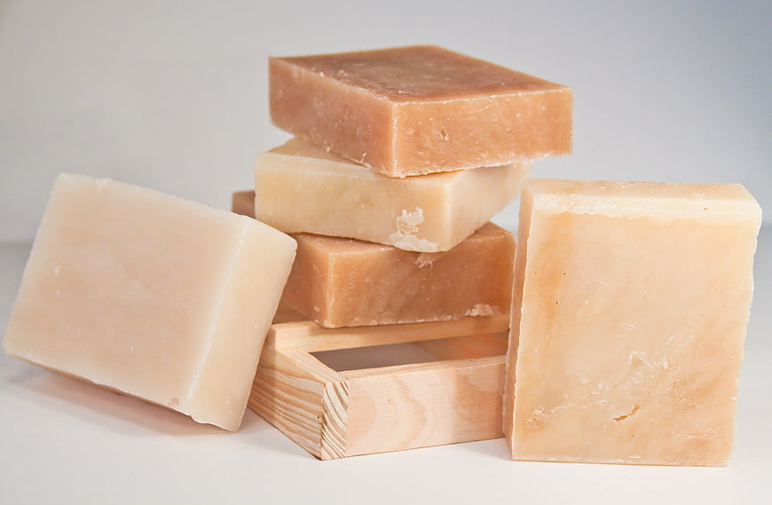 Stack of handmade natural soap bars on wooden box
