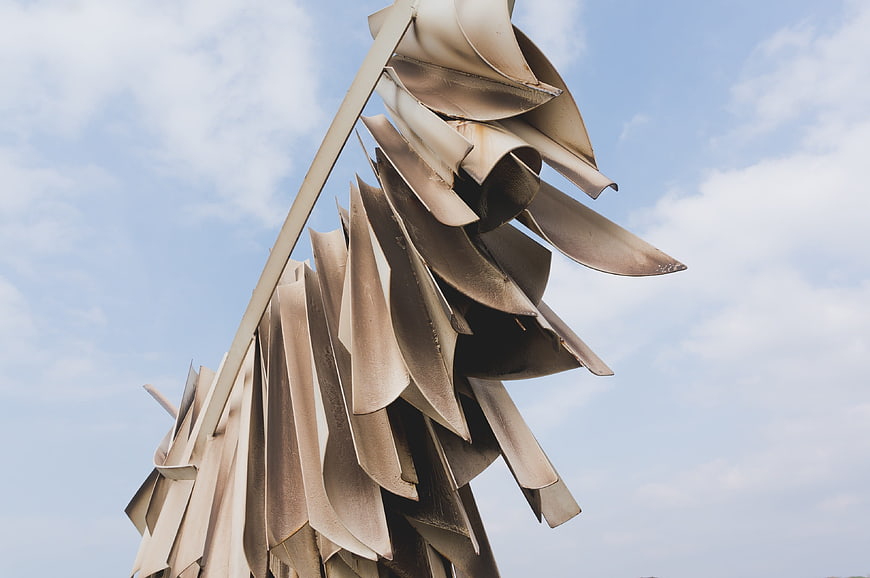 Abstract metal sculpture against blue sky