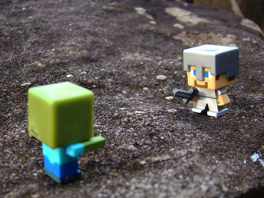 Minecraft Steve and Zombie Figures on Rock