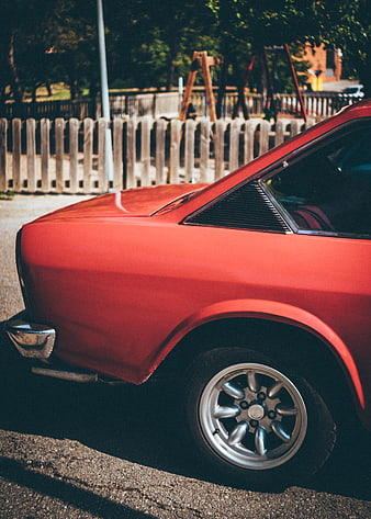Close-up of a vintage red classic car parked outdoors