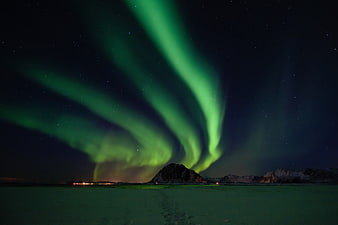 Vibrant Green Aurora Borealis Over Snowy Mountain Landscape