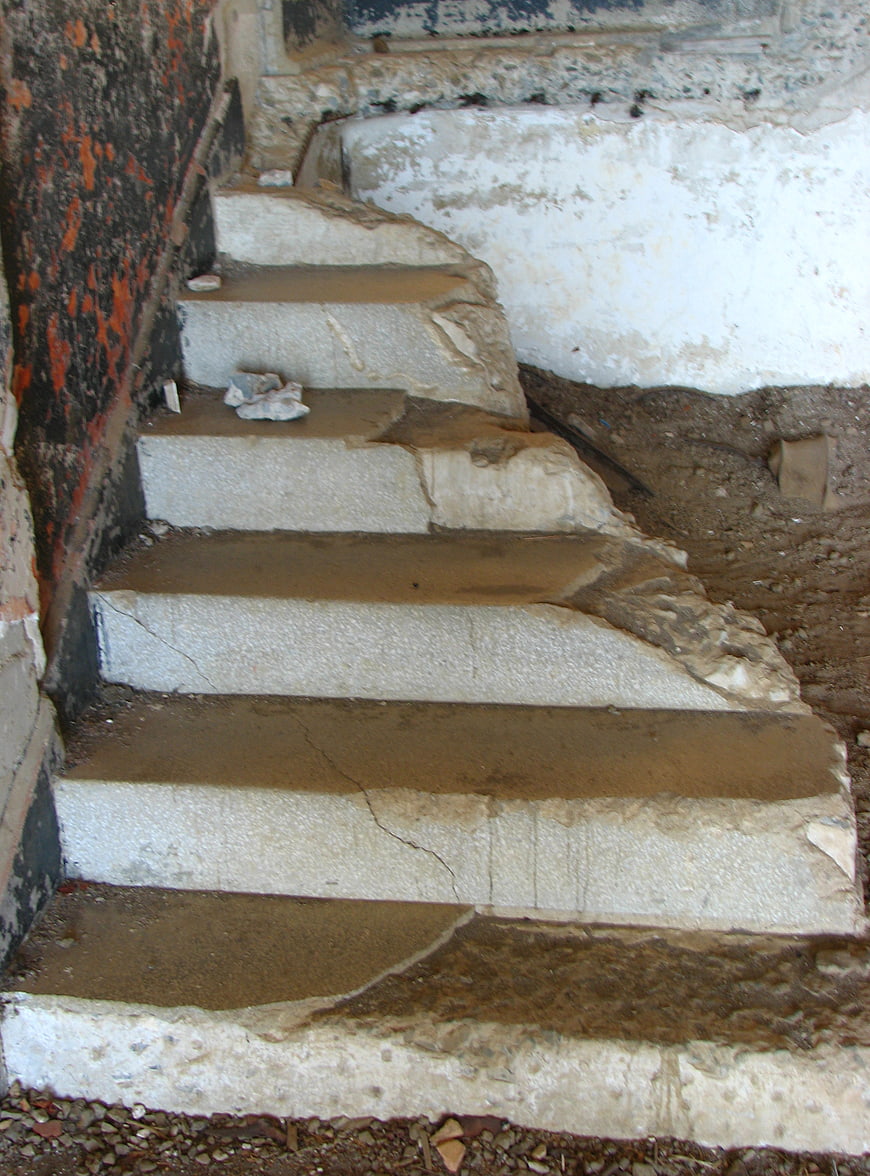Ruined stone staircase in abandoned building interior