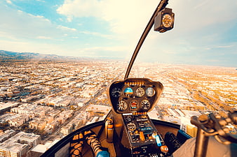 Helicopter Cockpit View Over Sprawling Urban Cityscape