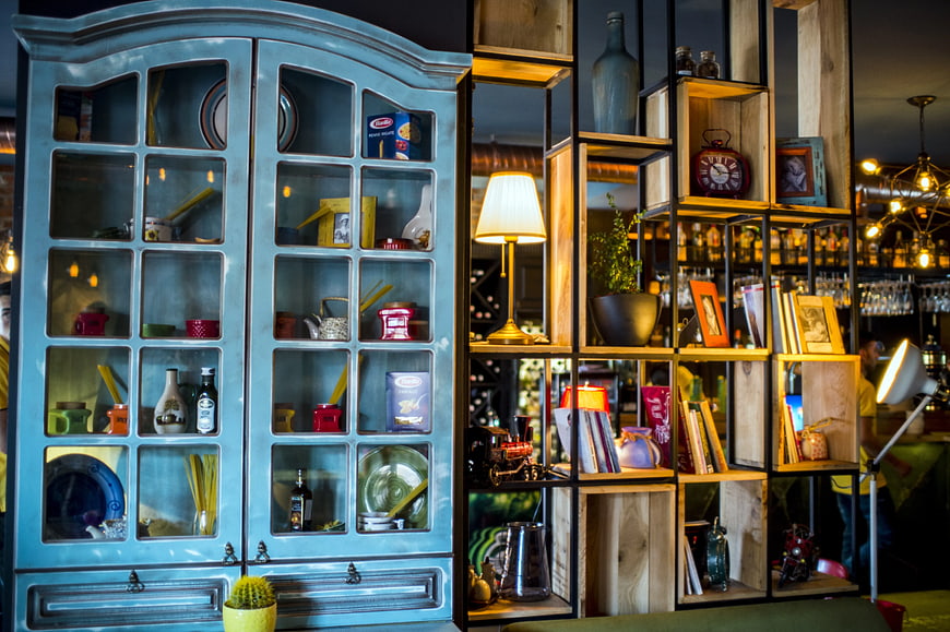 Vintage blue cabinet and wooden shelves in a cozy interior