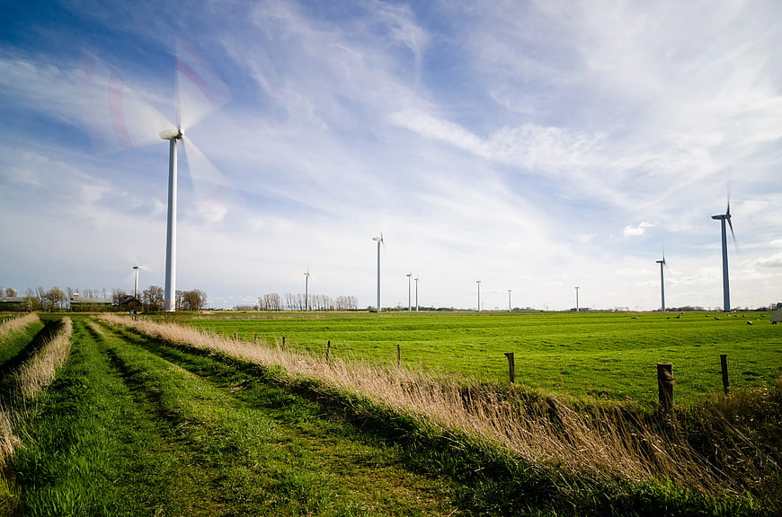 Wind Turbines in Green Pasture with Blue Sky