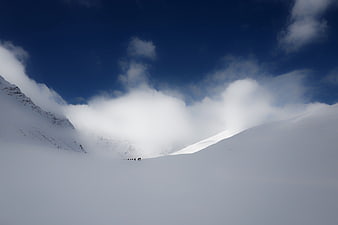 Group of mountaineers hiking through snowy mountain landscape
