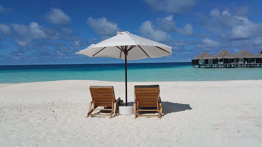 Tropical Beach Resort with Lounge Chairs and Overwater Bungalows