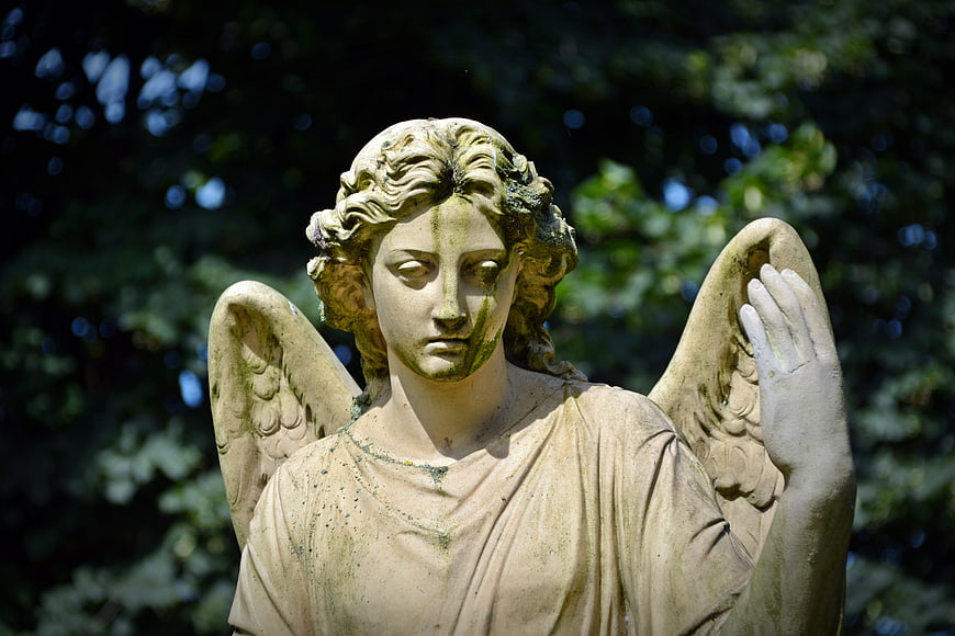 Weathered Stone Angel Statue in Garden Setting