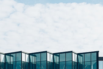 Modern Glass Building Facade Against Cloudy Sky