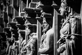 Black and white detail of Renaissance caryatid statues on a castle facade