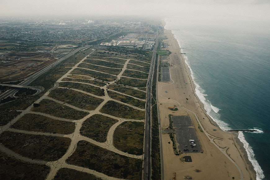 Aerial view of coastal highway, beach, and undeveloped land