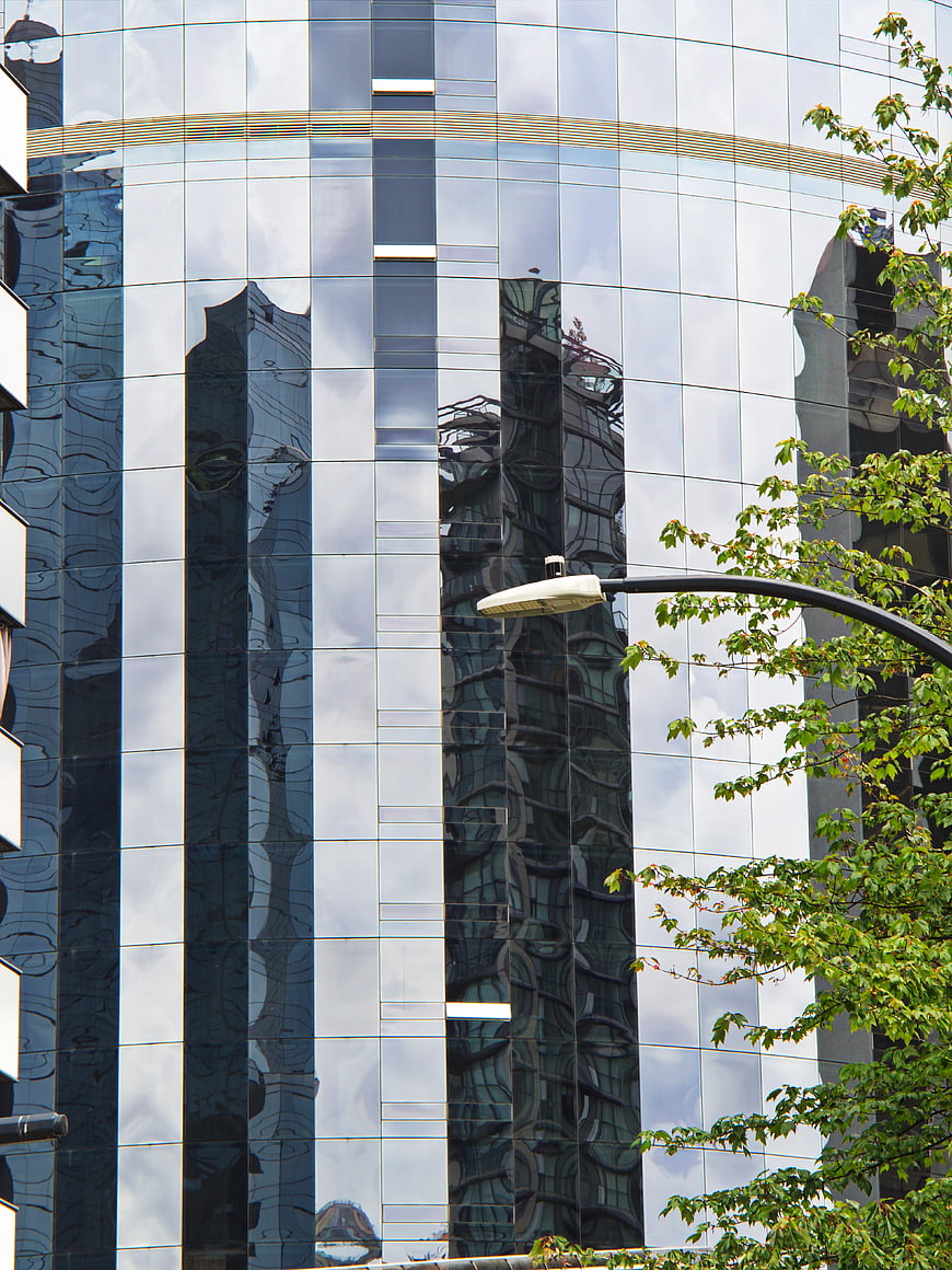 Modern Glass Building Reflection with Street Lamp and Tree