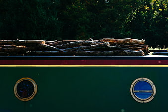 Stack of Firewood on Vintage Green Boat Hull
