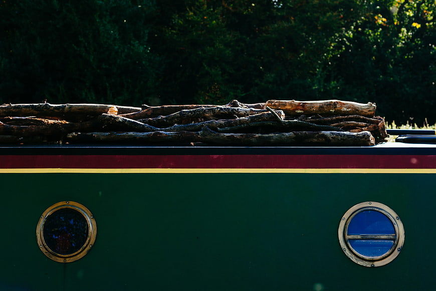 Stack of Firewood on Vintage Green Boat Hull