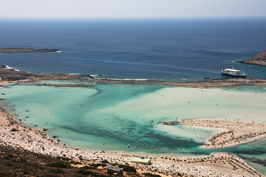 Aerial view of Balos Lagoon with turquoise water and cruise ship