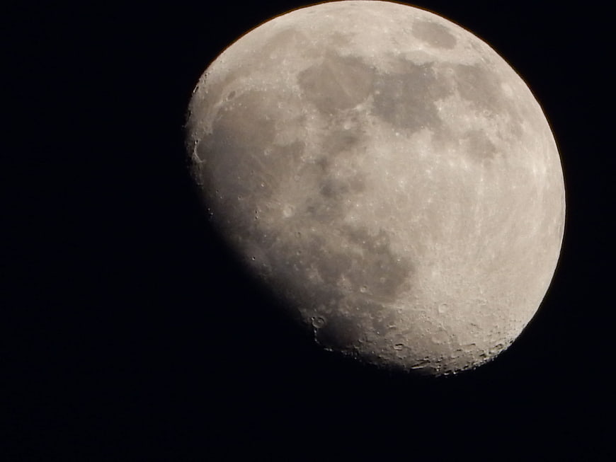 Close-up of a gibbous moon against a black night sky