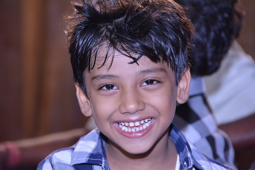 Smiling Indian Boy In Plaid Shirt
