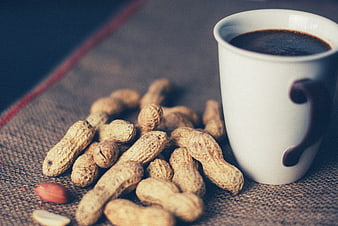 Peanuts in Shell and Coffee Cup on Burlap