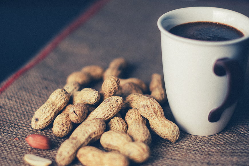 Peanuts in Shell and Coffee Cup on Burlap