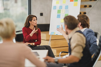 Woman in wheelchair leading business meeting with team