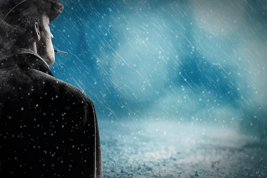 Man smoking in heavy rain with moody blue atmosphere
