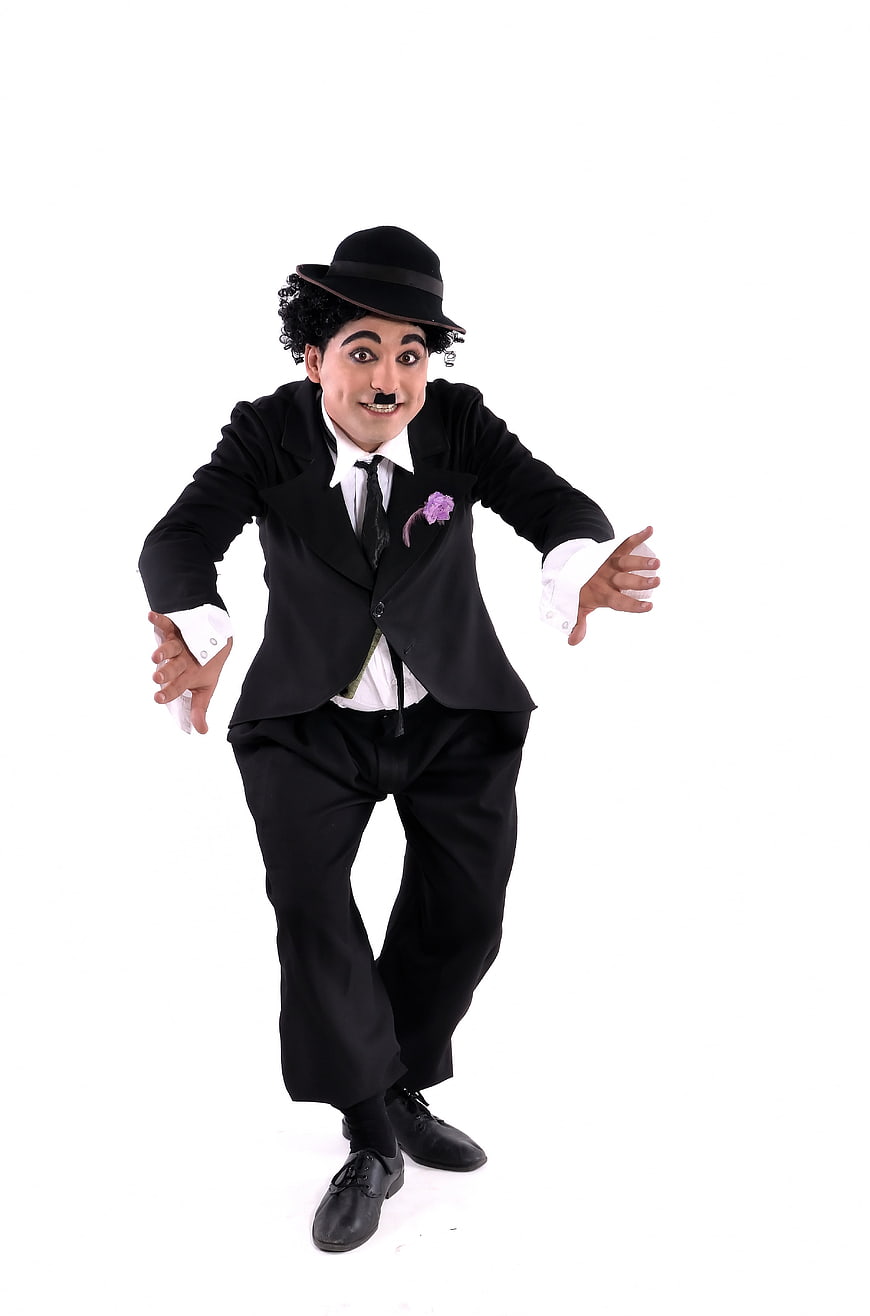 Man in Charlie Chaplin Costume with Bowler Hat and Mustache