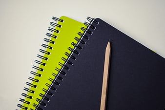 Minimalist black and green spiral notebooks with wooden pencil