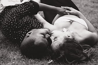 Romantic Black and White Photo of Couple Kissing on Grass