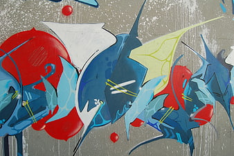 Abstract graffiti mural with blue and red shapes on concrete