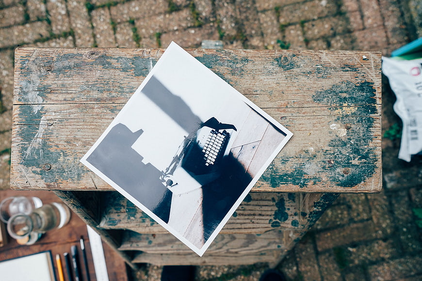 Black and white photo of typewriter on rustic wooden crate