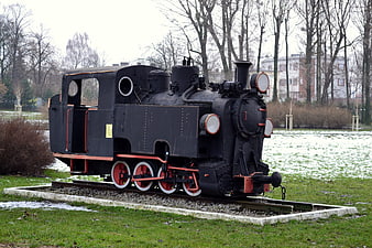 Vintage black steam locomotive on display in a park