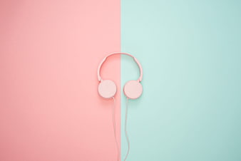 Pink headphones on pastel pink and mint green split background