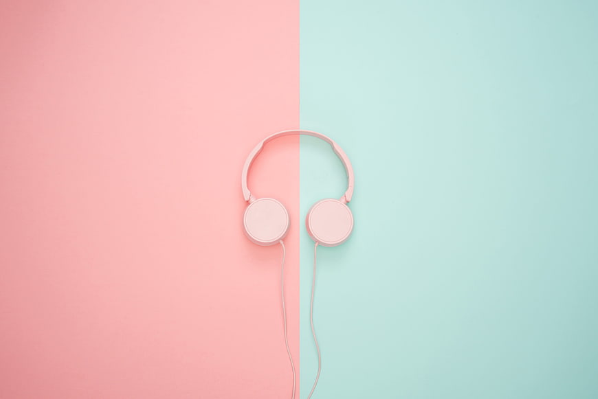 Pink headphones on pastel pink and mint green split background