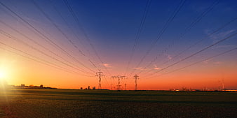 High Voltage Power Lines Silhouette at Sunset