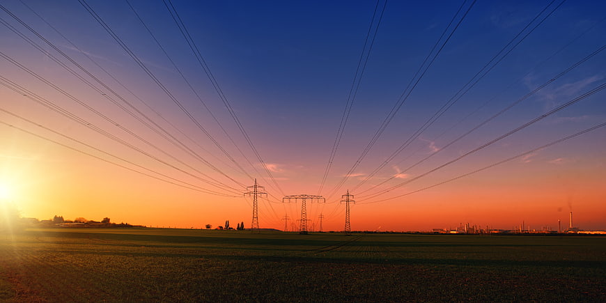 High Voltage Power Lines Silhouette at Sunset