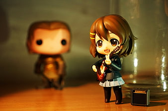 Anime figurine playing guitar with miniature amplifier