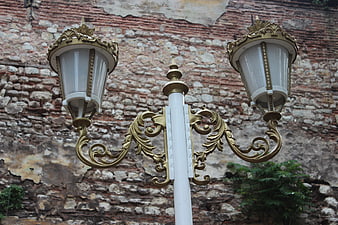 Ornate Vintage Street Lamp Against Old Brick Wall
