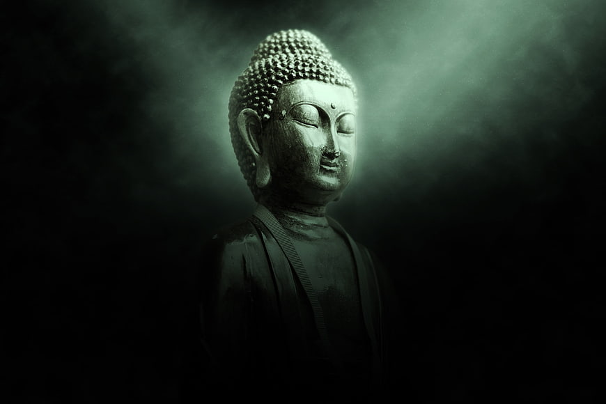 Serene Buddha Statue in Dramatic Dark Lighting