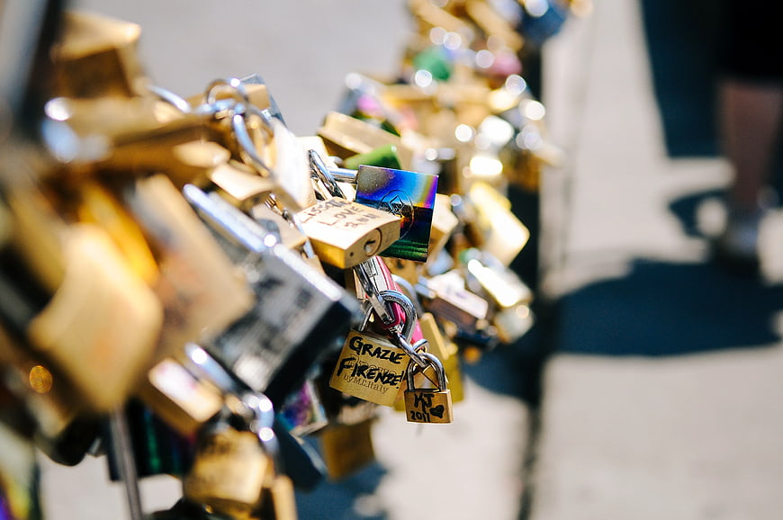 Close-up of love locks on a railing in Florence