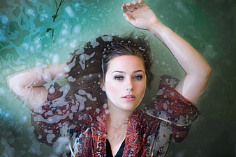 Woman Floating Underwater in Green Water with Bubbles