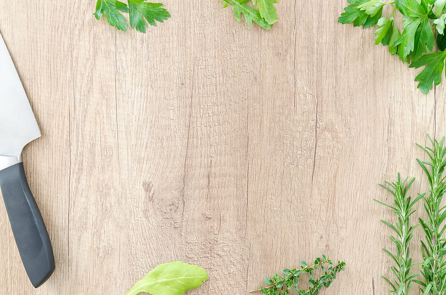 Fresh Herbs and Knife on Wooden Cutting Board Background
