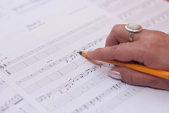 Hand Writing on Guitar Sheet Music with Pencil