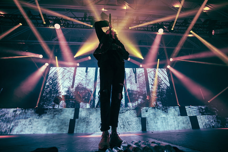 Silhouette of Singer Performing on Stage with Dramatic Lighting