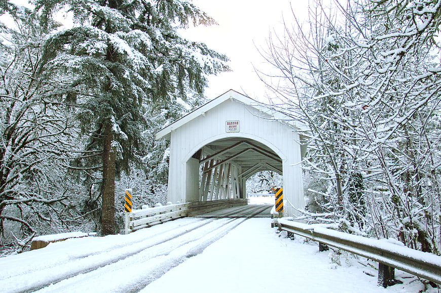 Snowy White Covered Bridge in Winter Forest