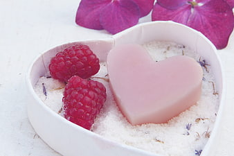 Heart-shaped pink soap with raspberries and bath salts