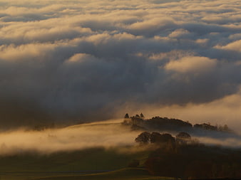 Golden Morning Fog Rolling Over Rolling Hills and Trees
