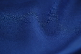 Close-up of textured blue fabric with soft folds