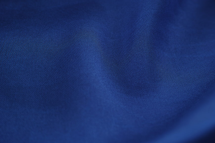 Close-up of textured blue fabric with soft folds