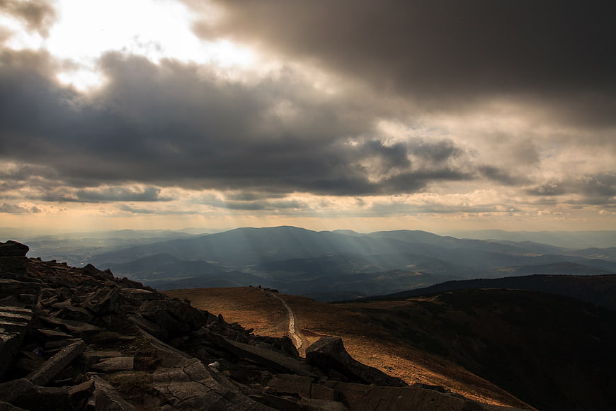 Dramatic Mountain Landscape with Sunbeams and Rocky Foreground